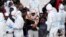 ITALY -- Migrants wait to disembark from Italian Coast Guard vessell "Diciotti" as it docks at the Sicilian port of Catania, southern Italy, Wednesday, June 13, 2018